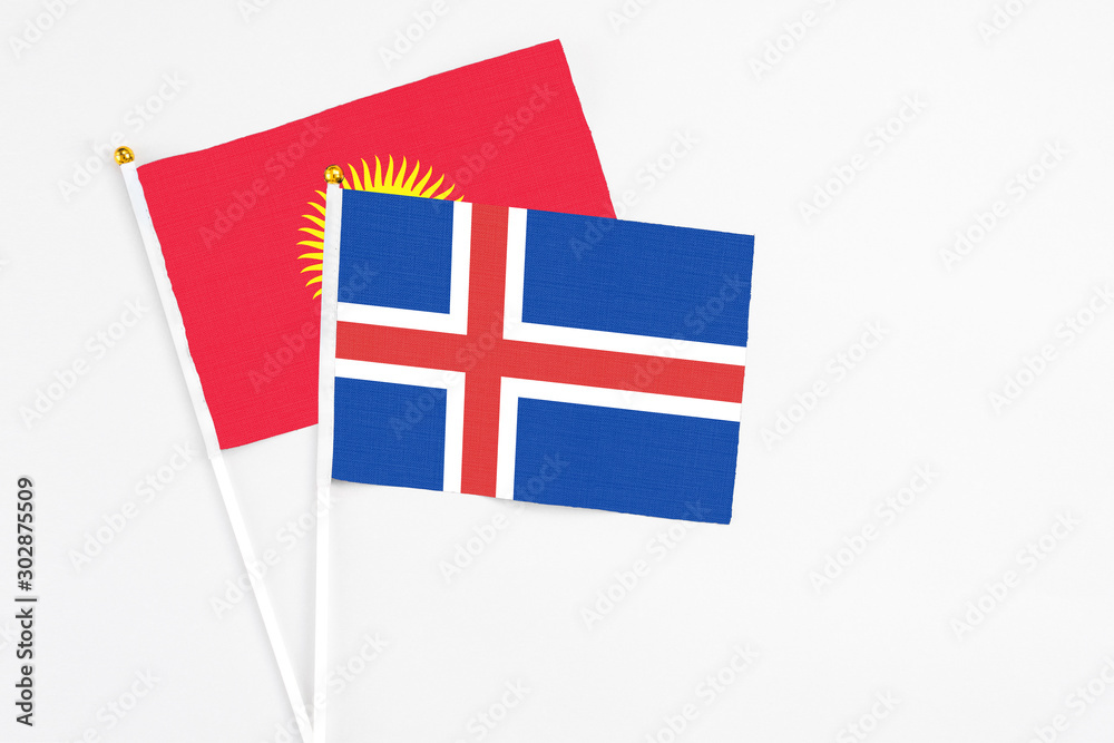 Iceland and Kyrgyzstan stick flags on white background. High quality fabric, miniature national flag. Peaceful global concept.White floor for copy space. Iceland and Kyrgyzstan stick flags on white background. High quality fabric, miniature national flag. Peaceful global concept.White floor for copy space.
