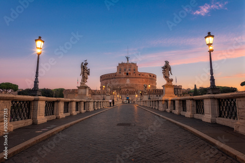 Ponte Sant'Angelo at dawn with Castel Sant'Angelo in background. Castel Santangelo fortress and bridge view in Rome, Italy. Saint Angel Castle with Tiber river in Rome, Italy at sunrise.