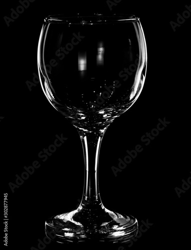  Glass of wine on a black background with glare reflected in it