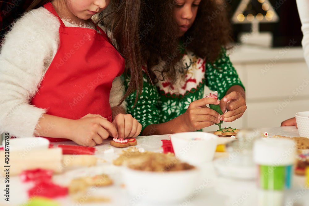 Two girls decorating Christmas cookies Two girls decorating Christmas cookies