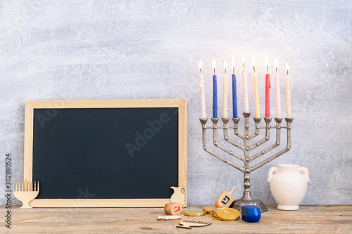 Menorah, dreidels and hanukkah coins with copy space