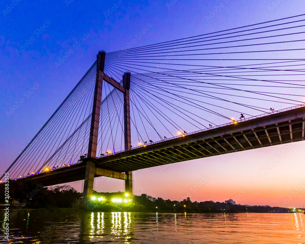Vidyasagar Setu Bridge in Kolkata, set against a sunset sky Vidyasagar Setu Bridge in Kolkata, set against a sunset sky