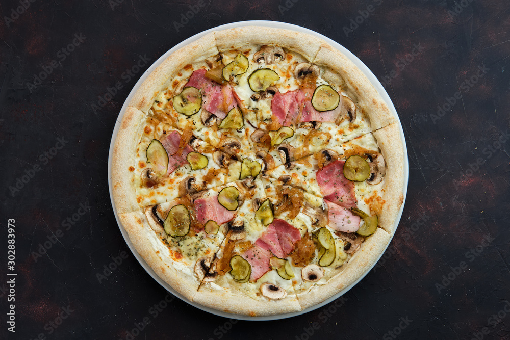 Top view of pizza with bacon, mushroom, pickled cucumber and caramelized onion Top view of pizza with bacon, mushroom, pickled cucumber and caramelized onion