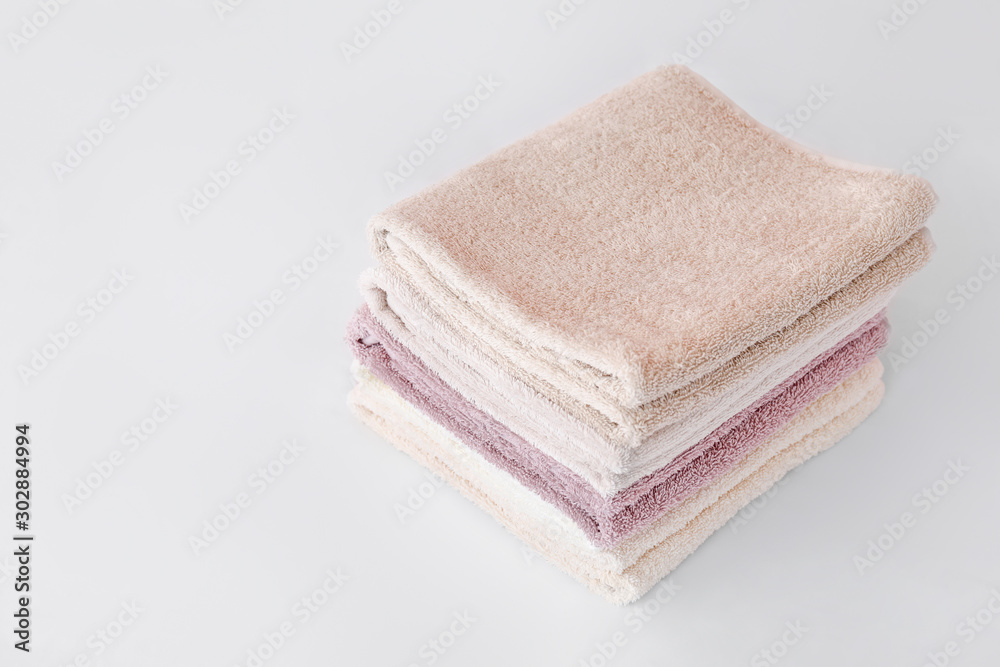 Stack of soft clean towels on bed Stack of soft clean towels on bed
