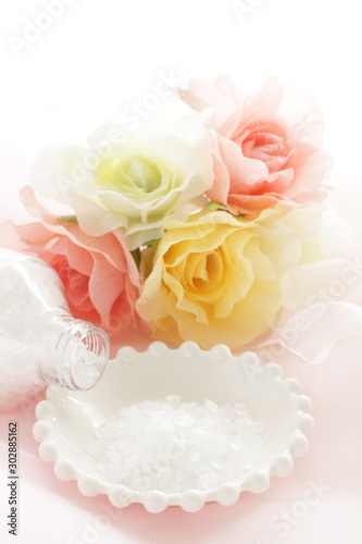 Rock salt on white plate with flower for beauty image