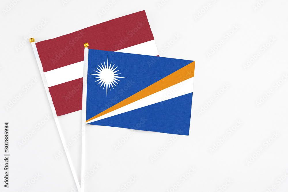 Marshall Islands and Latvia stick flags on white background. High quality fabric, miniature national flag. Peaceful global concept.White floor for copy space. Marshall Islands and Latvia stick flags on white background. High quality fabric, miniature national flag. Peaceful global concept.White floor for copy space.