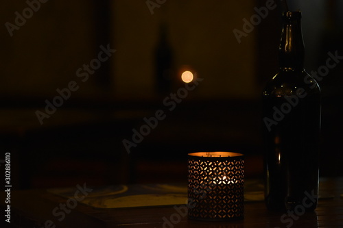 Candle on the table in the gloom