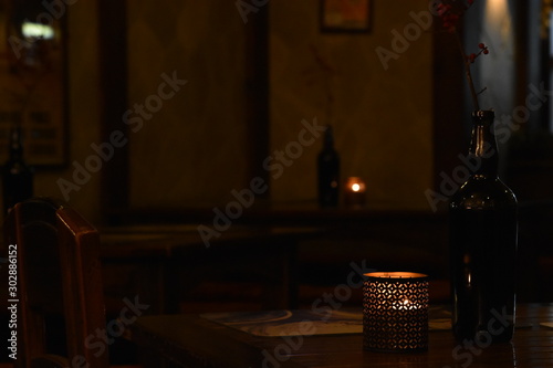 Candle on the table in the gloom