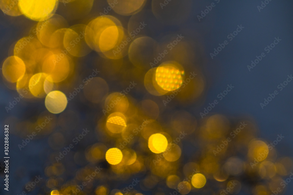Out of focus gold light particles. Golden dust sparkle. abstract blur With Blinking Bokeh bright party lights Abstract Glitter Defocused abstract background. Golden yellow bokeh lights