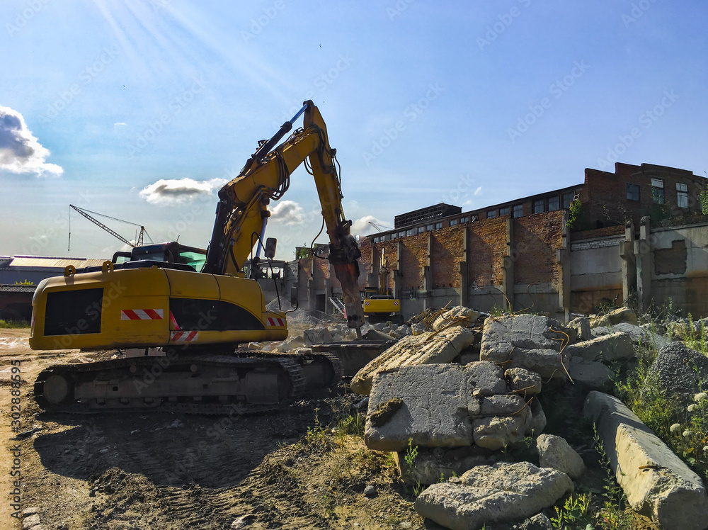 Demolition house using excavator in city. Rebuilding process. Remove equipment. Demolition house using excavator in city. Rebuilding process. Remove equipment.