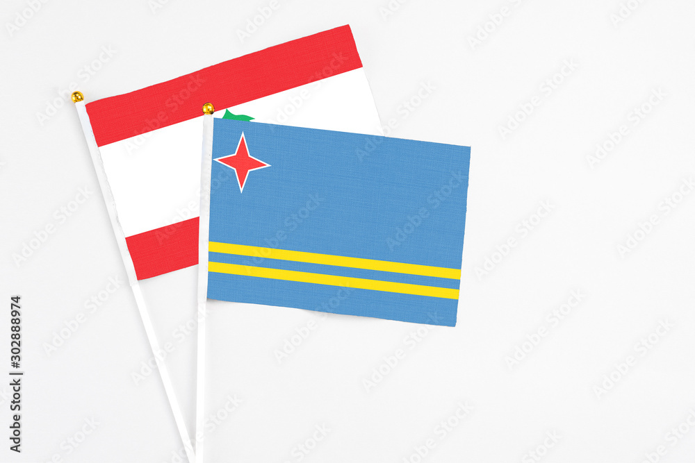 Aruba and Lebanon stick flags on white background. High quality fabric, miniature national flag. Peaceful global concept.White floor for copy space. Aruba and Lebanon stick flags on white background. High quality fabric, miniature national flag. Peaceful global concept.White floor for copy space.