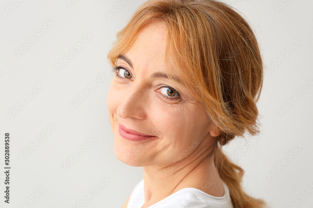 Mature woman with healthy skin on light background Mature woman with healthy skin on light background