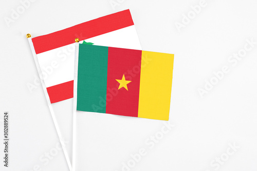Cameroon and Lebanon stick flags on white background. High quality fabric  miniature national flag. Peaceful global concept.White floor for copy space.