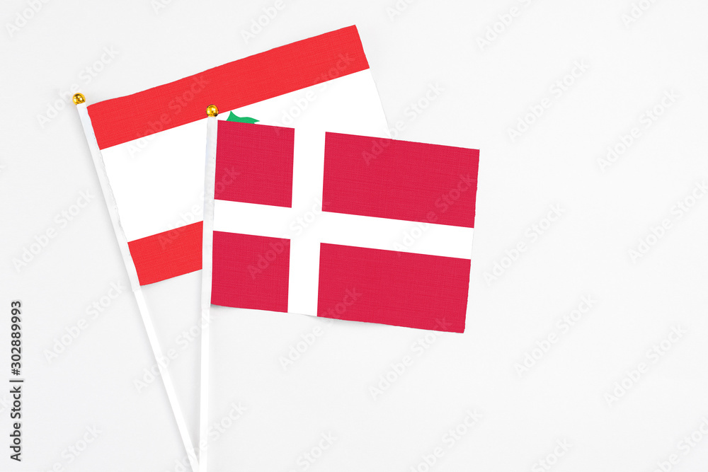 Denmark and Lebanon stick flags on white background. High quality fabric, miniature national flag. Peaceful global concept.White floor for copy space.