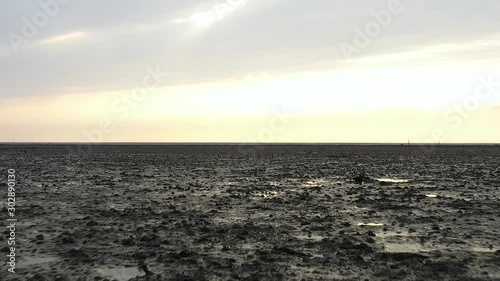 Forward low flying drone aerial view of Taiwan countryside wetlands with birds flying over it photo