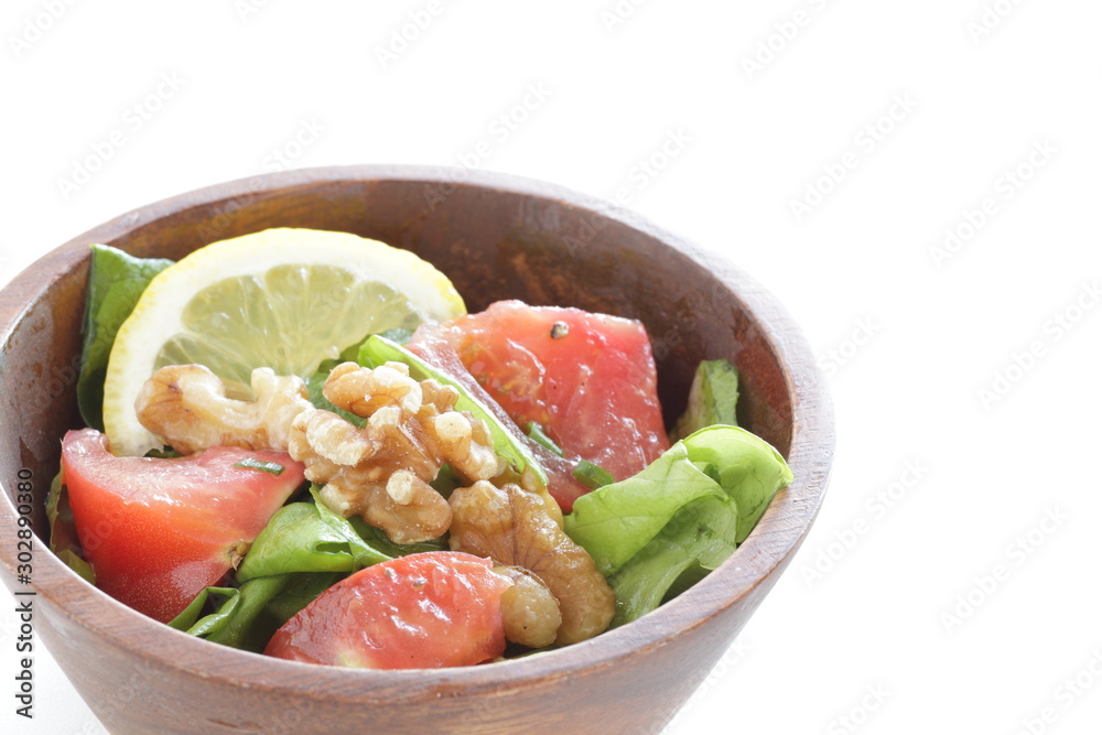 Tomato and walnut salad on white background with copy space Tomato and walnut salad on white background with copy space