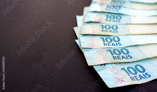 Brazilian Real banknotes on black background. Concept of economy, savings and salary.
