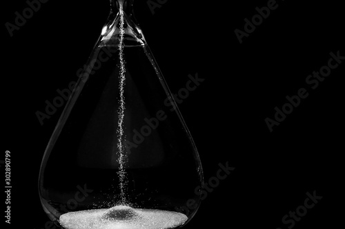 Crystal hourglass on dark background, closeup © Pixel-Shot