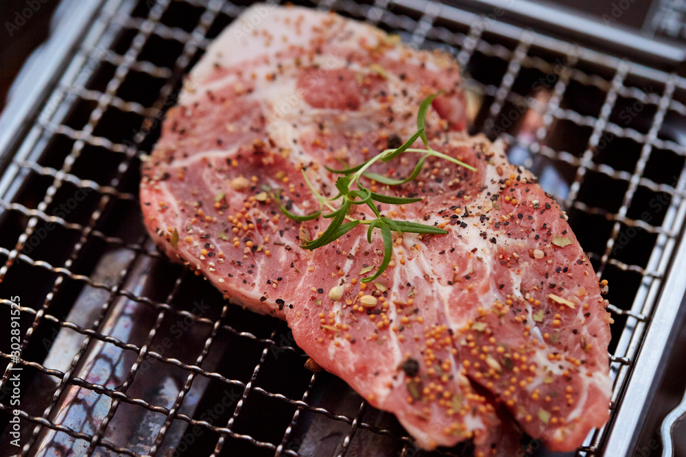 Steak meat with herb and spice on grill Steak meat with herb and spice on grill