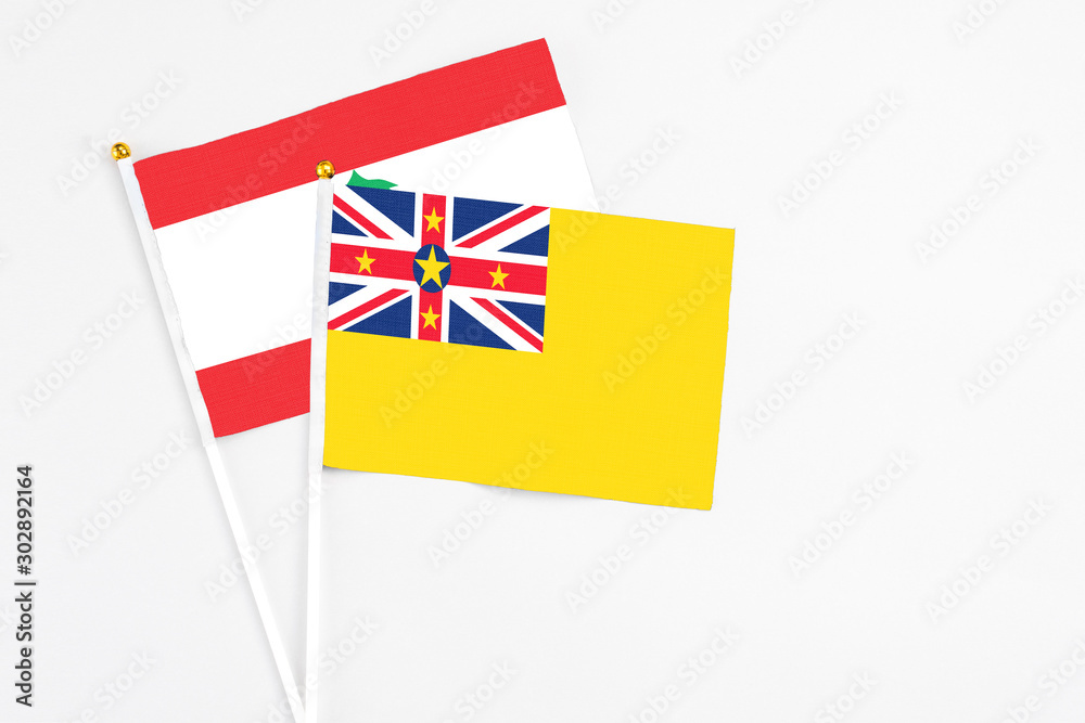 Niue and Lebanon stick flags on white background. High quality fabric, miniature national flag. Peaceful global concept.White floor for copy space. Niue and Lebanon stick flags on white background. High quality fabric, miniature national flag. Peaceful global concept.White floor for copy space.