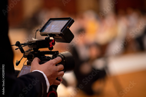 Behind the scenes of movie shooting or video production and film crew team with camera equipment at outdoor location