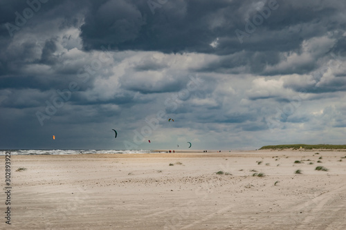 sand dunes and blue sky with kitesurfers