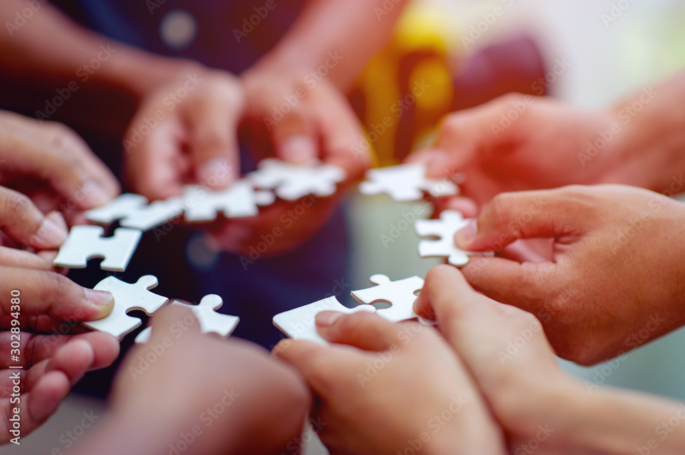 Team work, hands and jig Saw Unite with power Is a good team of successful people Team work concept Team work, hands and jig Saw Unite with power Is a good team of successful people Team work concept