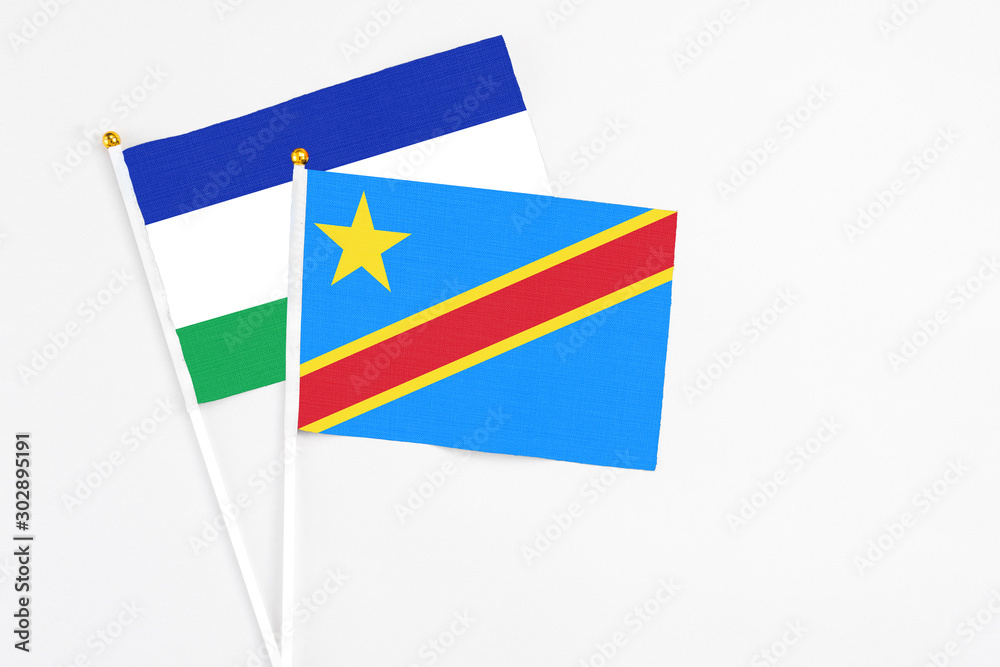 Congo and Lesotho stick flags on white background. High quality fabric, miniature national flag. Peaceful global concept.White floor for copy space. Congo and Lesotho stick flags on white background. High quality fabric, miniature national flag. Peaceful global concept.White floor for copy space.