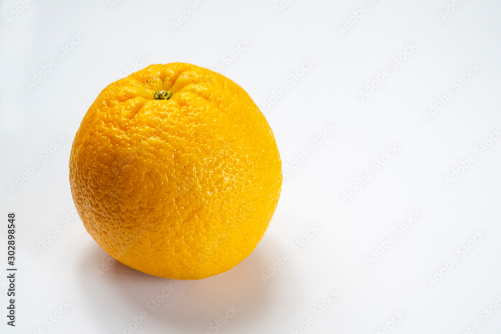 peeled orange and divided into slices on a white background peeled orange and divided into slices on a white background