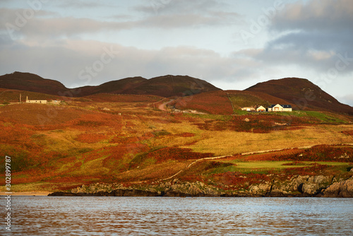 Konstfotografi A view of the rocky shore of a small town Port Ellen on a sunny day