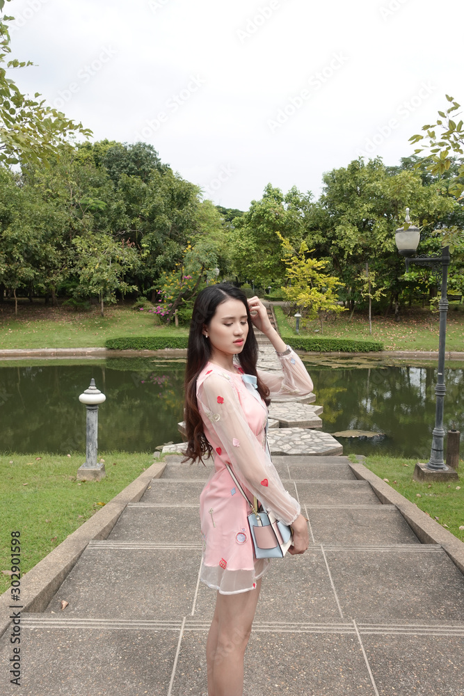 Young asian woman relaxing in a public park