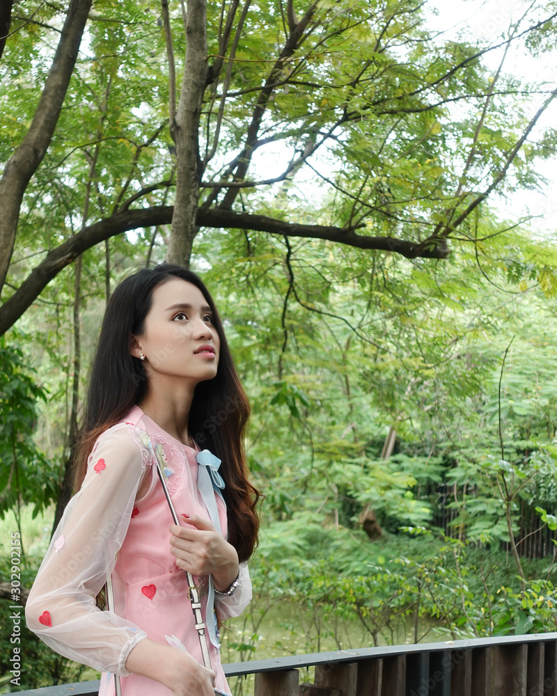 Young asian woman relaxing in a public park Young asian woman relaxing in a public park