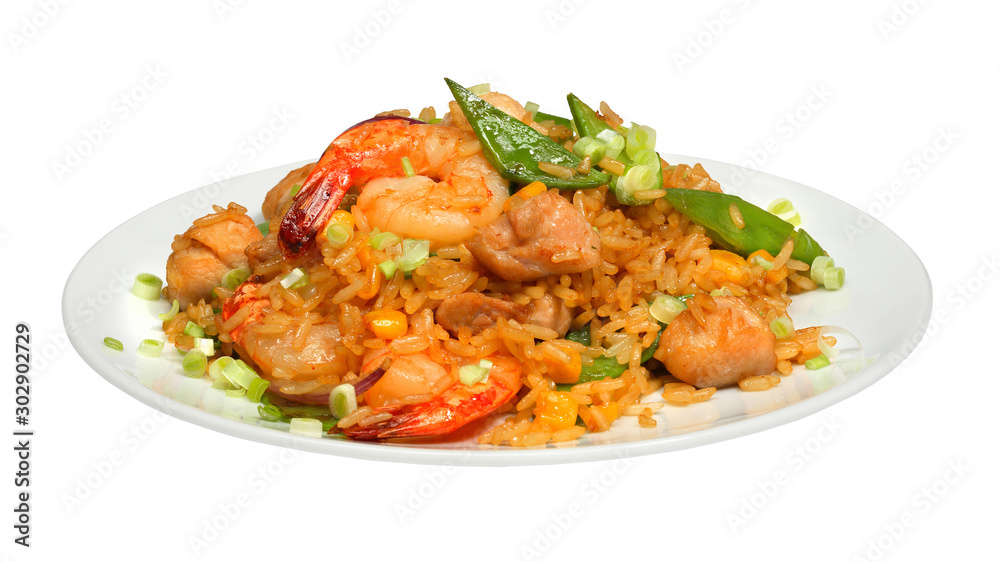 Rice with chicken meat, shrimps and vegetables on white round plate
