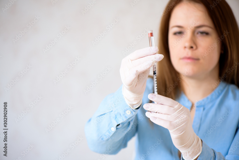A girl fills a syringe for insulin injections. Diabetes. The short-acting insulin. Insulin injection at home. A girl fills a syringe for insulin injections. Diabetes. The short-acting insulin. Insulin injection at home.