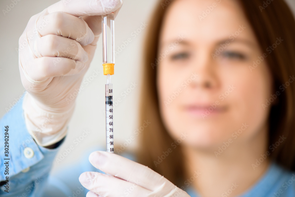 A girl fills a syringe for insulin injections. Diabetes. The short-acting insulin. Insulin injection at home. A girl fills a syringe for insulin injections. Diabetes. The short-acting insulin. Insulin injection at home.
