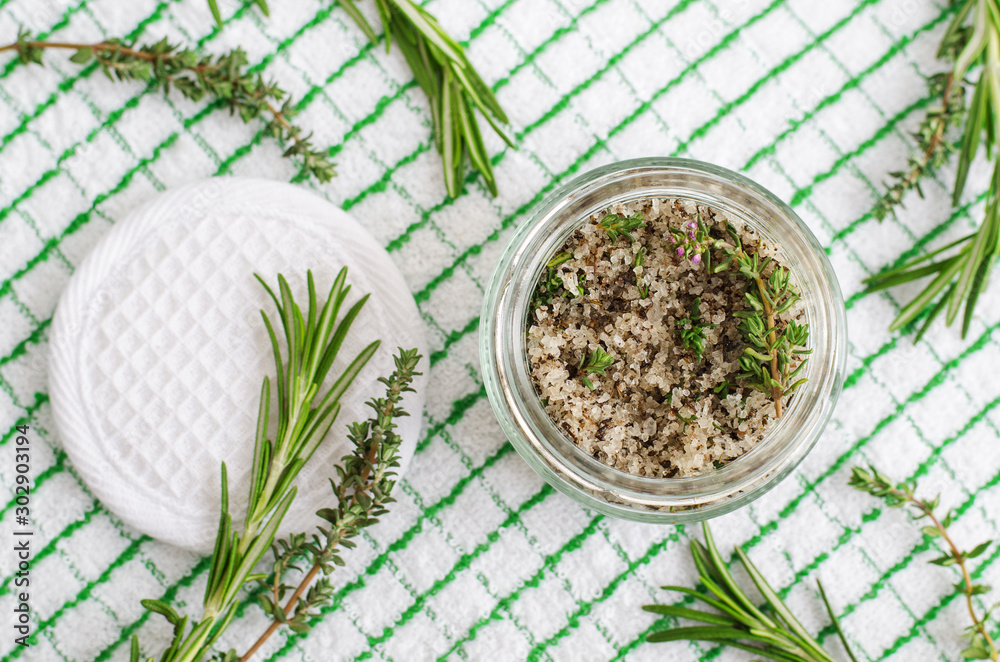 Homemade herbal scrub (foot soak or bath salt) with rosemary, thyme, sea salt and olive oil. Natural skin and hair care. DIY beauty treatments and spa recipe. Top view, copy space   - obrazy, fototapety, plakaty 