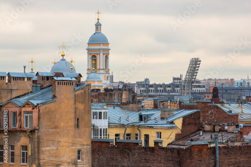 The historical center of St. Petersburg, Russia. Top view on the roofs of old buildings and on the church. Above the houses rises the beautiful bell tower of Vladimir Cathedral. Sights of Petersburg.