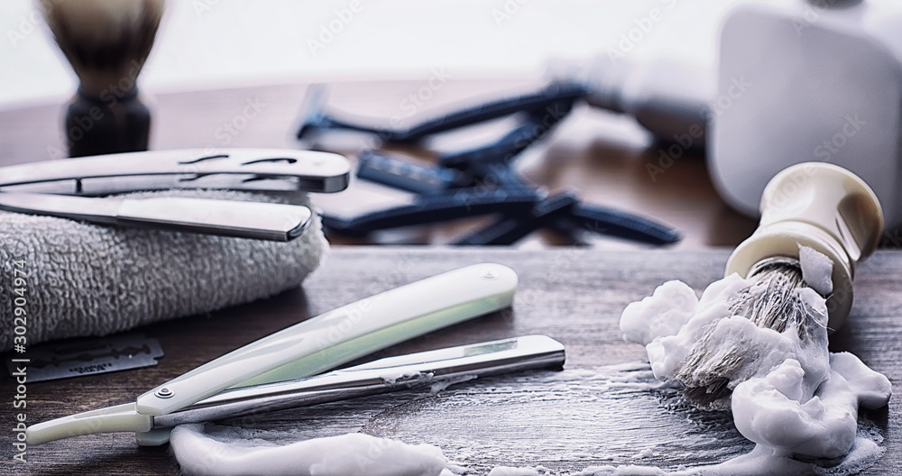 Shaving accessories on a wooden texture background. Tools. Disposable shaving machine, brush, foam and hazard razor. Shaving accessories on a wooden texture background. Tools. Disposable shaving machine, brush, foam and hazard razor.