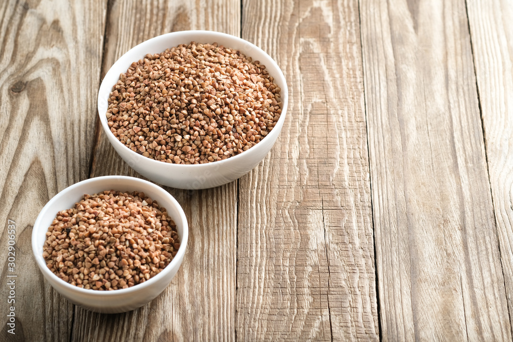Buckwheat in a light bowl on a rustic background copy space. Buckwheat in a light bowl on a rustic background copy space.