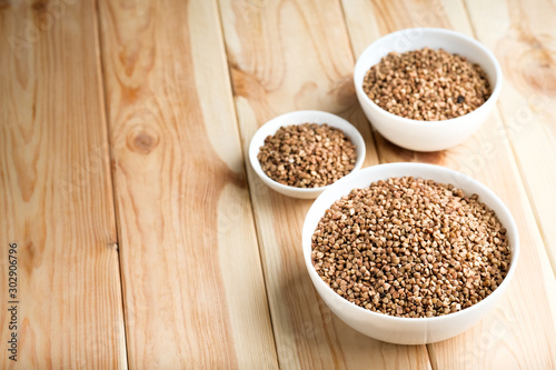 Buckwheat in a light bowl on a rustic background copy space. photo