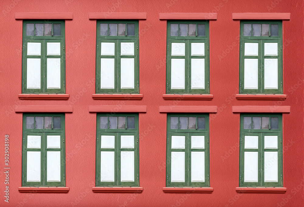 Traditional windows on bright red walls Traditional windows on bright red walls