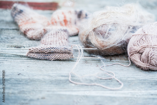 Fotografering Woolen thread with incomplete knitting socks on vintage wooden background