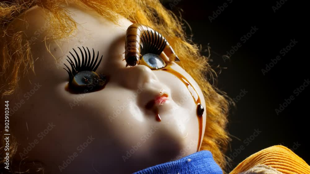 Vintage creepy head of doll with blood and worms.