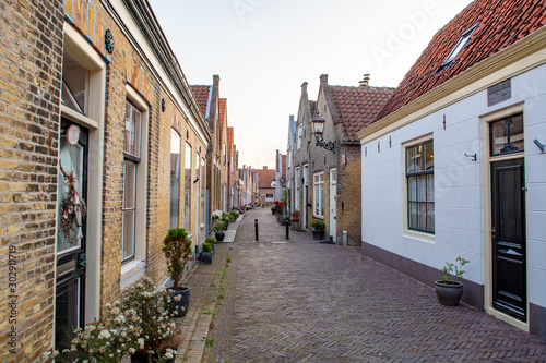 Street view in small Dutch town Goedereede on sunset, Zeeland, Netherlands © barmalini