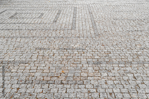 Cobblestone pavement. The sidewalk is lined with cobblestones. Masonry background.