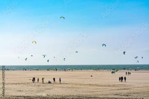 Water sport event, kite surfers race in North Sea near Renesse, Zeeland, Netherlands