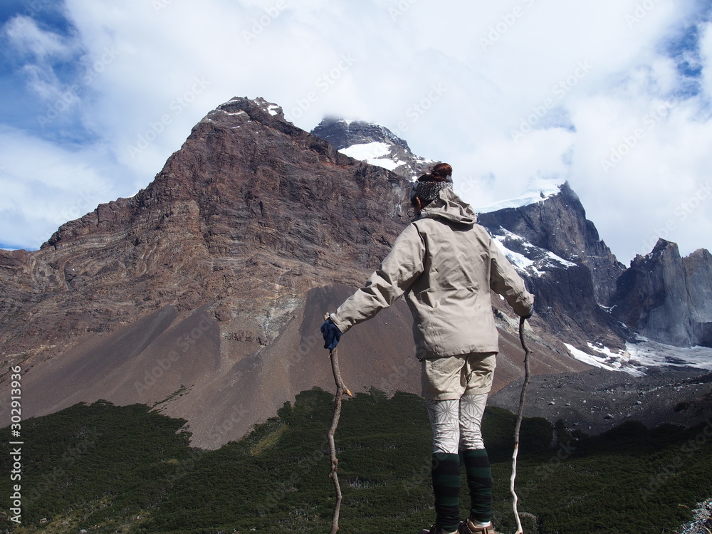 A woman climber with two sticks to view the great outdoors, Torres del Paine trekking, Torres del Paine National Park, Patagonia, Chile