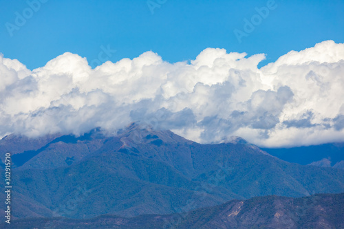 View of the peaks of the mountains in Kakheti and white clouds on blue sky. © k_samurkas