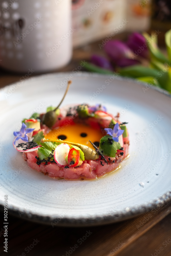 Tuna Tartar with Avocado on white plate, molecular Haute cuisine Tuna Tartar with Avocado on white plate, molecular Haute cuisine