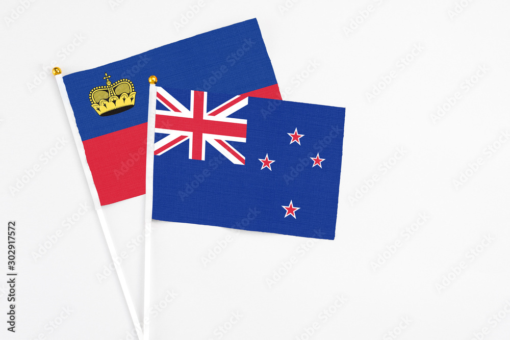 New Zealand and Liechtenstein stick flags on white background. High quality fabric, miniature national flag. Peaceful global concept.White floor for copy space. New Zealand and Liechtenstein stick flags on white background. High quality fabric, miniature national flag. Peaceful global concept.White floor for copy space.